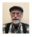 Photo of Daniel McKnight, smiling, man, short white hair, cap, glasses